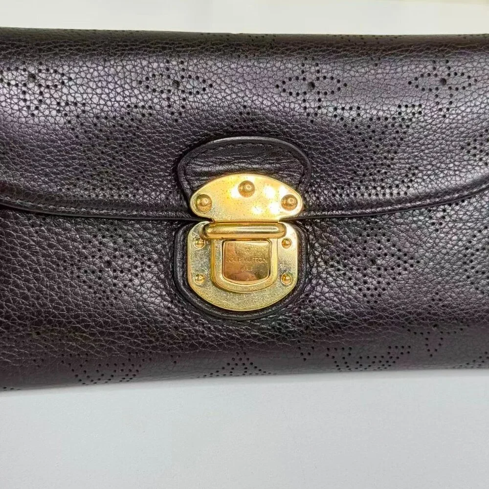 Louis Vuitton Black Monogram Canvas Wallet with Gold Hinge Detail Elegant Design
